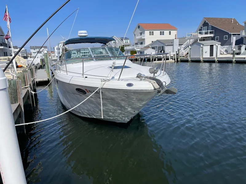 Slide: The Image of 2001 Sea Ray 290 Amberjack boat docked in a marina, surrounded by waterfront homes. - 4