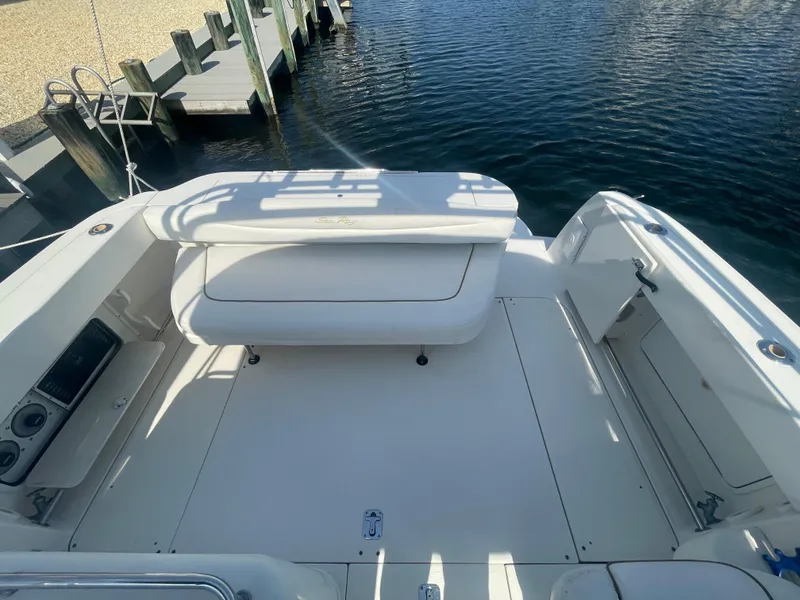 Slide: The Image of 2001 Sea Ray 290 Amberjack boat deck with seating, docked by the water. - 40