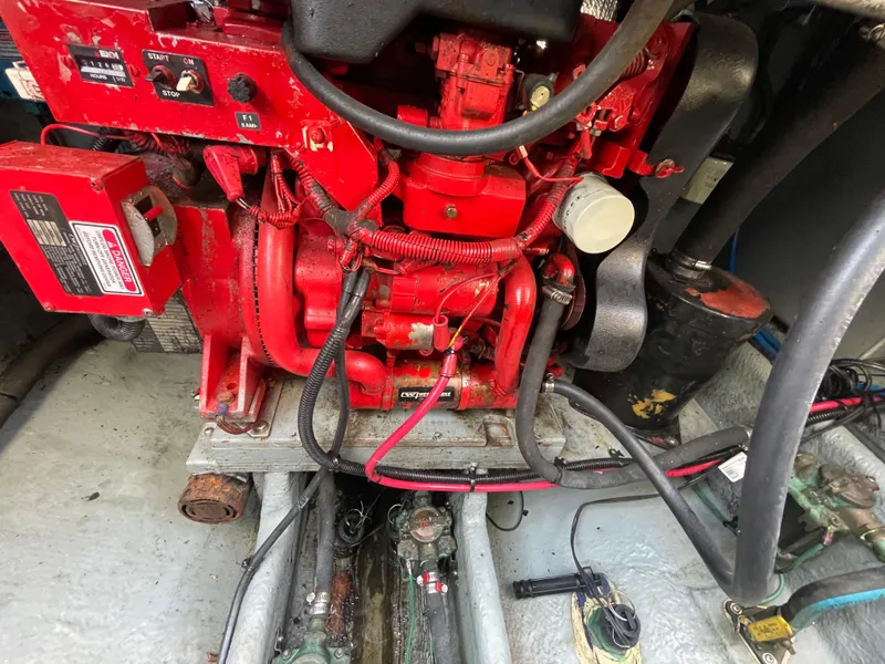 Slide: The Image of Engine compartment of a 2001 Sea Ray 290 Amberjack boat, featuring a red engine. - 42