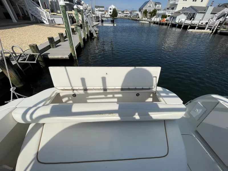 Slide: The Image of 2001 Sea Ray 290 Amberjack boat docked in a serene marina setting. - 5