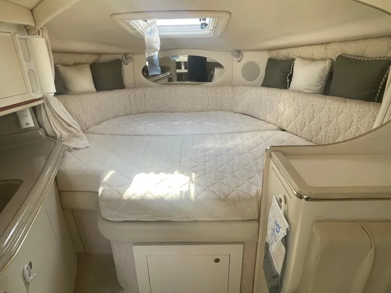 Slide: The Image of Cozy cabin interior of 2001 Sea Ray 290 Amberjack with bed and skylight. - 6