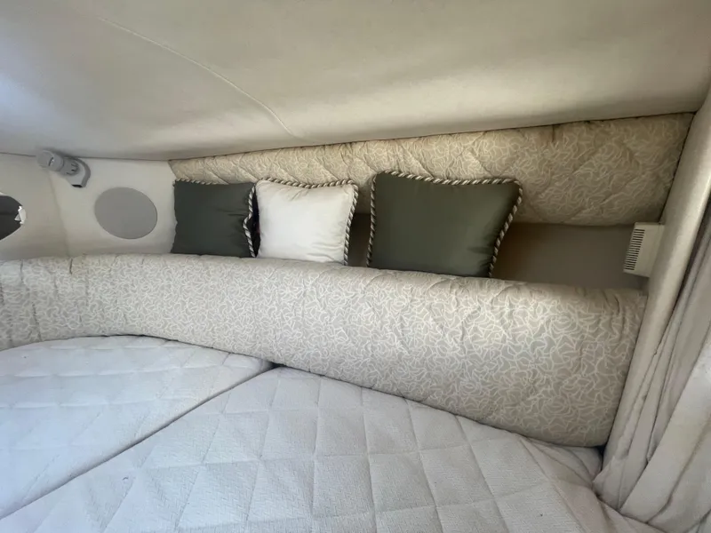 Slide: The Image of Interior cabin of 2001 Sea Ray 290 Amberjack with cushioned seating and decorative pillows. - 8