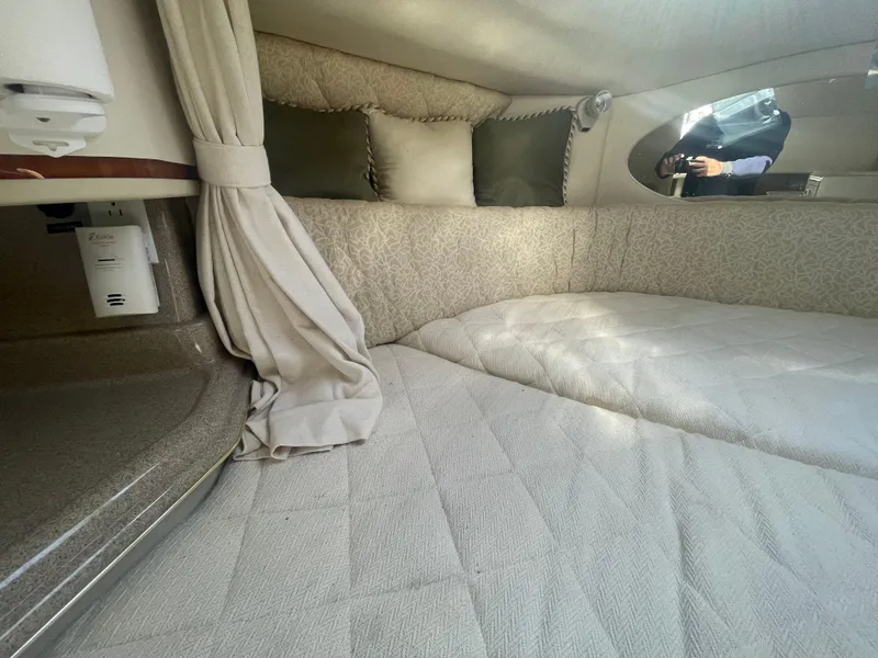 Slide: The Image of 2001 Sea Ray 290 Amberjack cabin interior with cozy bedding and elegant decor. - 9