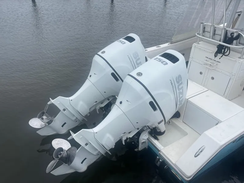 Slide: The Image of 2006 Regulator 24 FS boat with twin Suzuki outboard engines on water. - 5