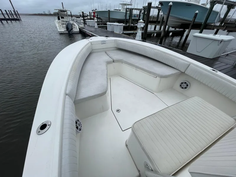 Slide: The Image of 2006 Regulator 24 FS boat with spacious seating at a marina dock. - 6