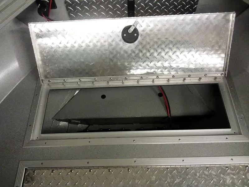 Slide: The Image of 2024 Smoker Craft Phantom 18 X2 boat storage compartment with diamond plate lid. - 12