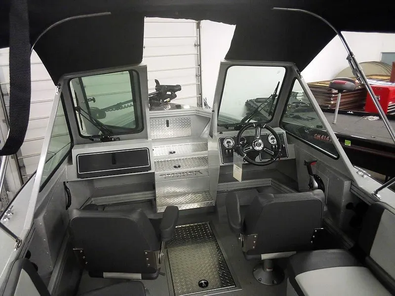 Slide: The Image of 2024 Smoker Craft Phantom 18 X2 boat interior with steering wheel and seating. - 13