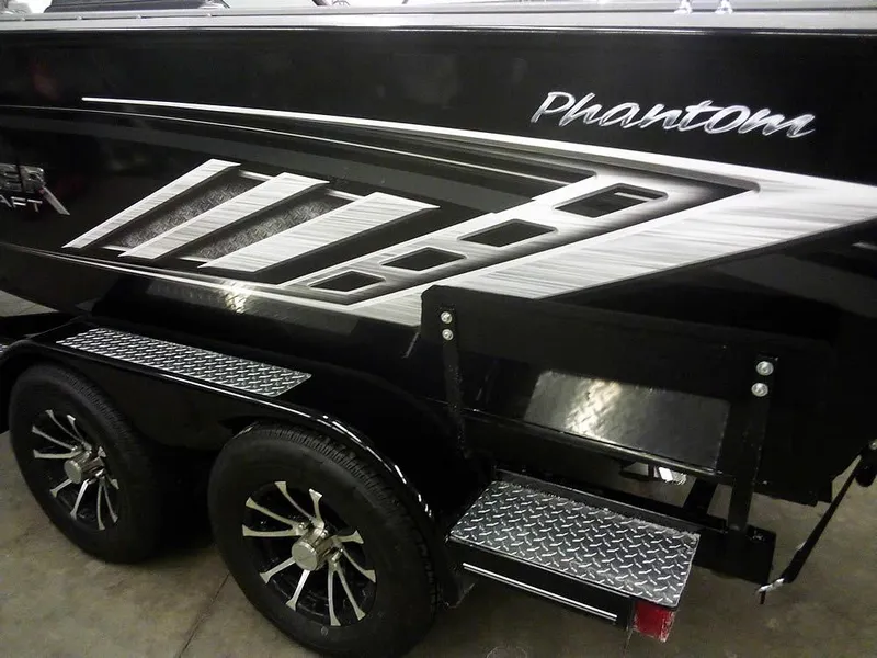 Slide: The Image of 2024 Smoker Craft Phantom 18 X2 boat with sleek design and dual axle trailer. - 2