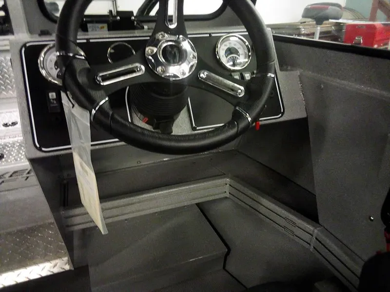 Slide: The Image of 2024 Smoker Craft Phantom 18 X2 boat dashboard with steering wheel and gauges. - 21