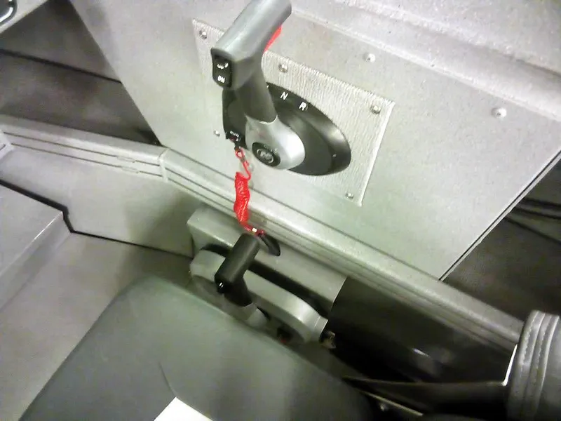 Slide: The Image of 2024 Smoker Craft Phantom 18 X2 boat control panel with throttle and gear lever. - 22