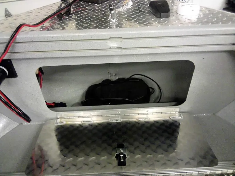 Slide: The Image of 2024 Smoker Craft Phantom 18 X2 boat storage compartment with diamond plate finish. - 24