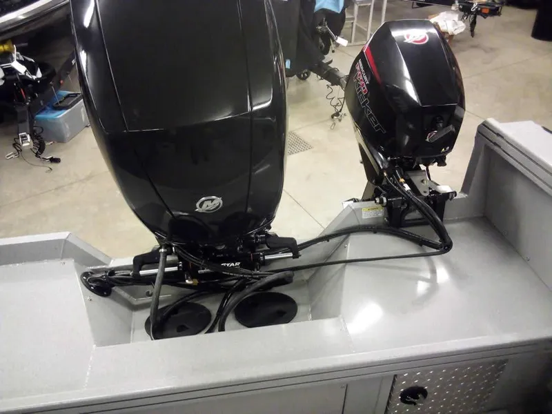 Slide: The Image of 2024 Smoker Craft Phantom 18 X2 boat with dual outboard motors in a garage setting. - 27