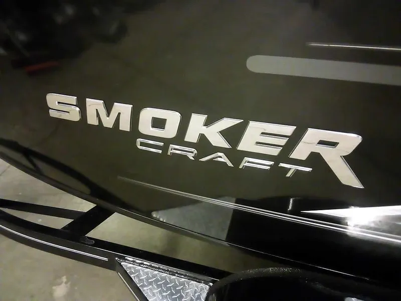 Slide: The Image of 2024 Smoker Craft Phantom 18 X2 boat logo on a sleek black surface. - 6