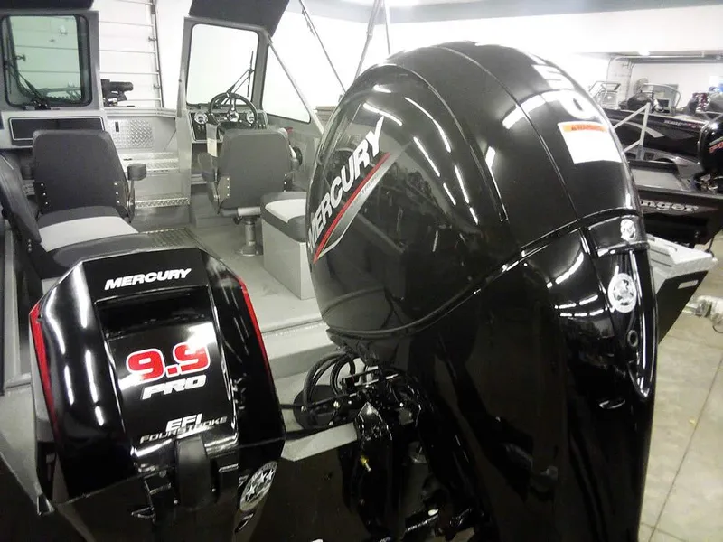 Slide: The Image of 2024 Smoker Craft Phantom 18 X2 with Mercury outboard engines in showroom. - 8
