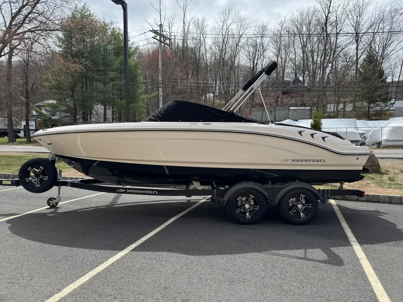 The Image of 2025 Chaparral 21 SSi I/O boat on trailer in parking lot, side view. - 0