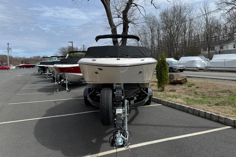 Slide: The Image of 2025 Chaparral 21 SSi I/O boat parked in a lot, front view. - 2