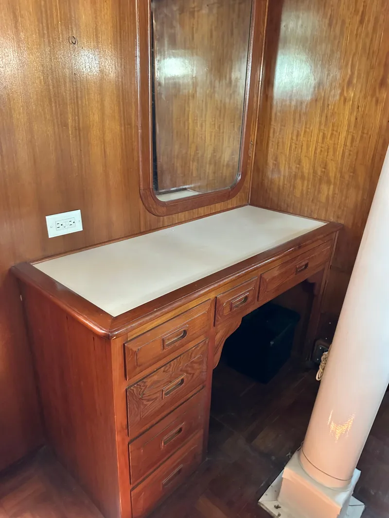 Slide: The Image of Wooden vanity with mirror on 1981 Island Trader 46 yacht, featuring drawers and classic design. - 17