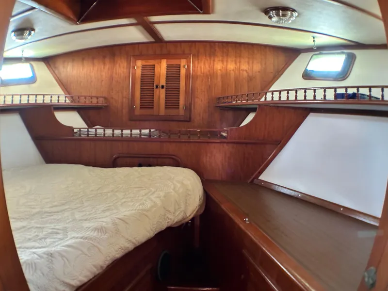 Slide: The Image of 1981 Island Trader 46 yacht cabin with wooden interior and cozy bed. - 21