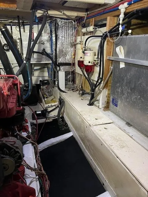 Slide: The Image of Engine room of 1981 Island Trader 46 boat with visible machinery and wiring. - 27