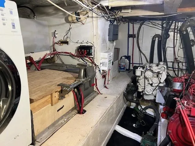 Slide: The Image of Engine room of 1981 Island Trader 46 with machinery and wiring visible. - 28