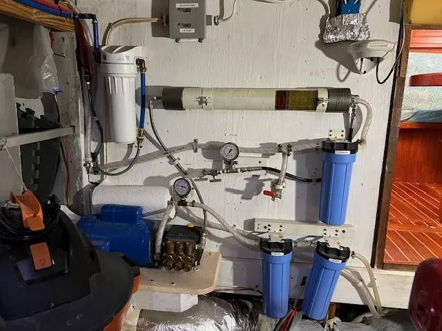 Slide: The Image of Water filtration system in a 1981 Island Trader 46 boat, featuring multiple filters and gauges. - 29