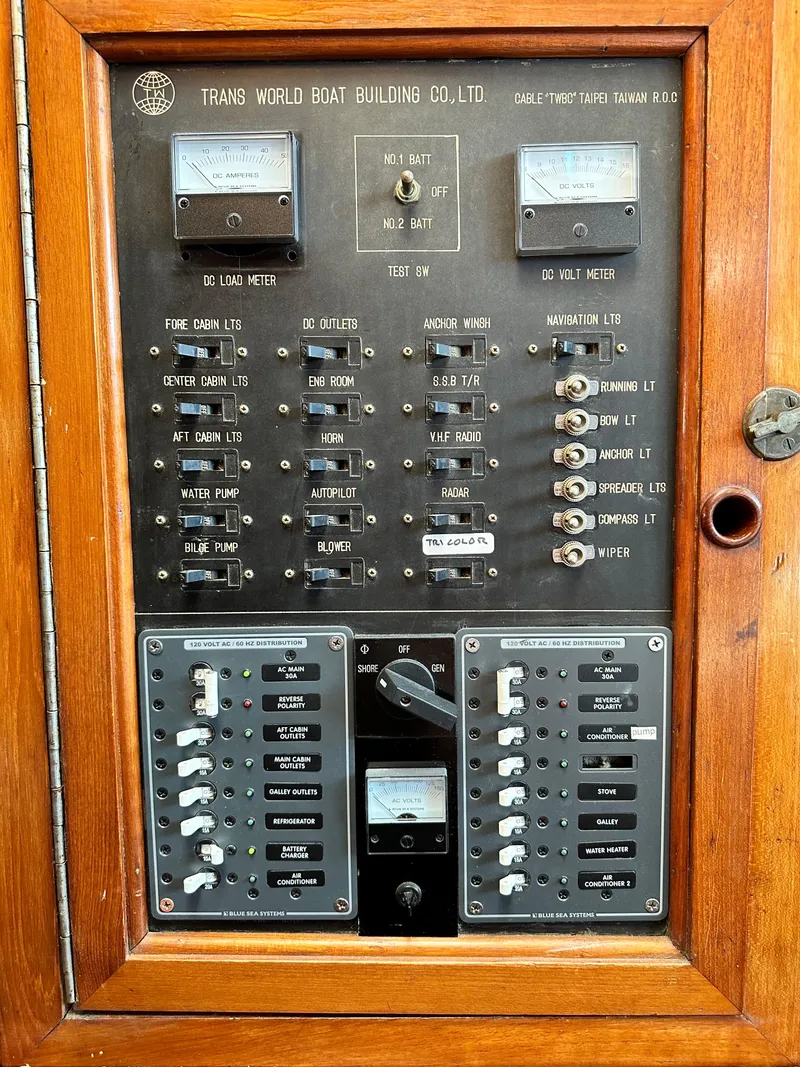 Slide: The Image of Electrical control panel of a 1981 Island Trader 46 boat, featuring various switches and meters. - 31