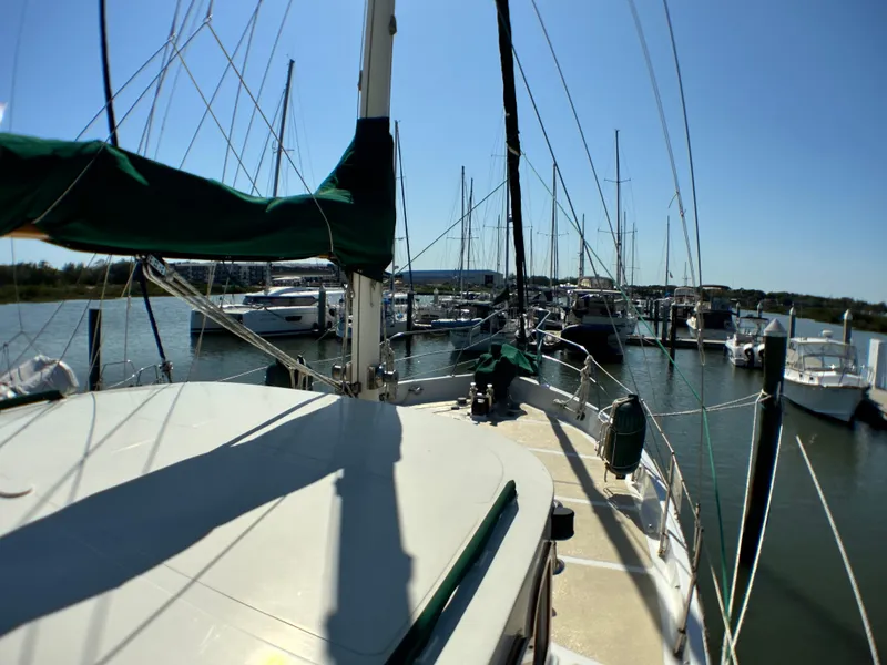 Slide: The Image of Sailboat docked in marina, Island Trader 46, 1981 model, sunny day, calm waters. - 32