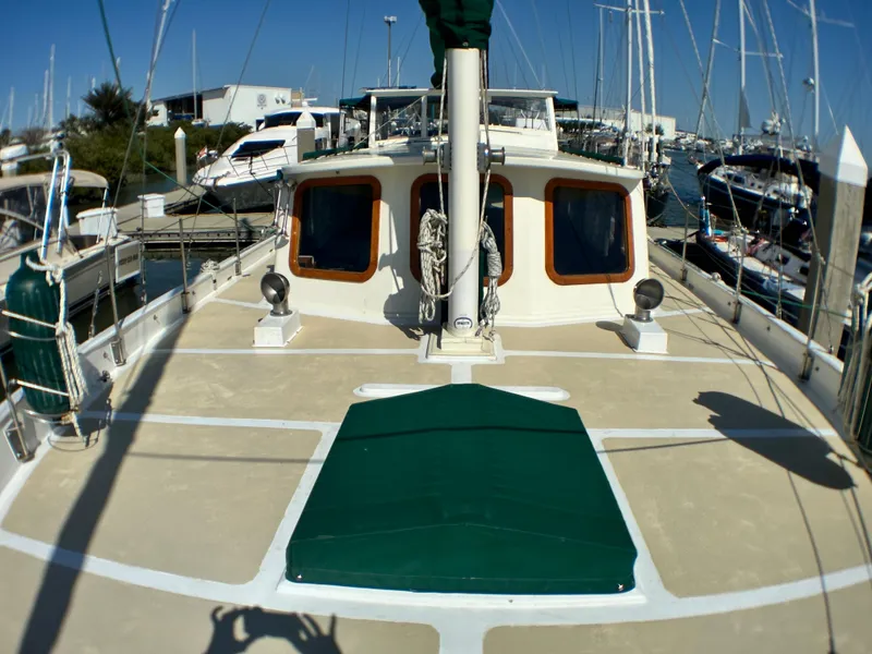 Slide: The Image of 1981 Island Trader 46 sailboat docked at marina, featuring spacious deck and classic design. - 33