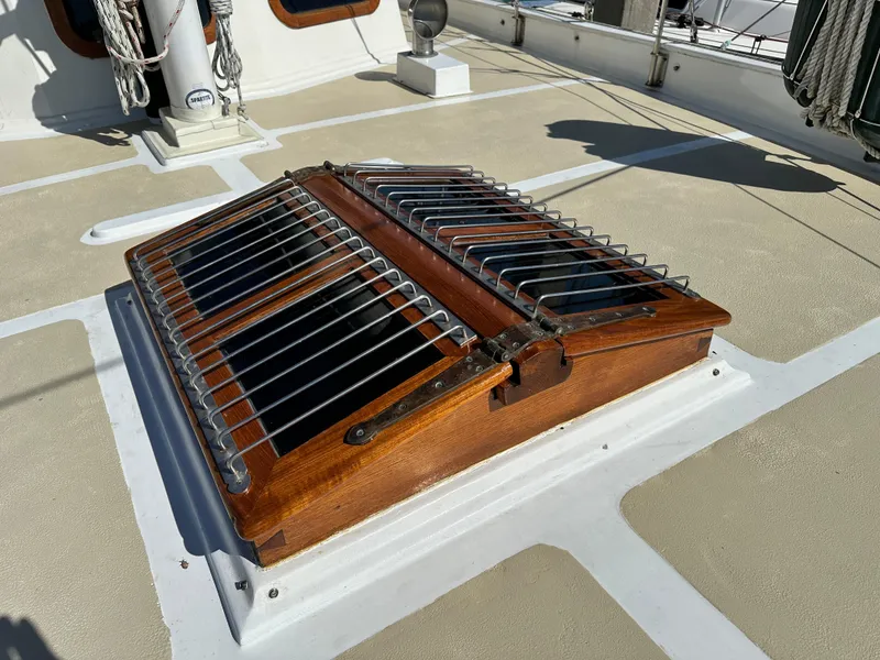 Slide: The Image of Wooden hatch on 1981 Island Trader 46 sailboat deck with metal bars. - 35