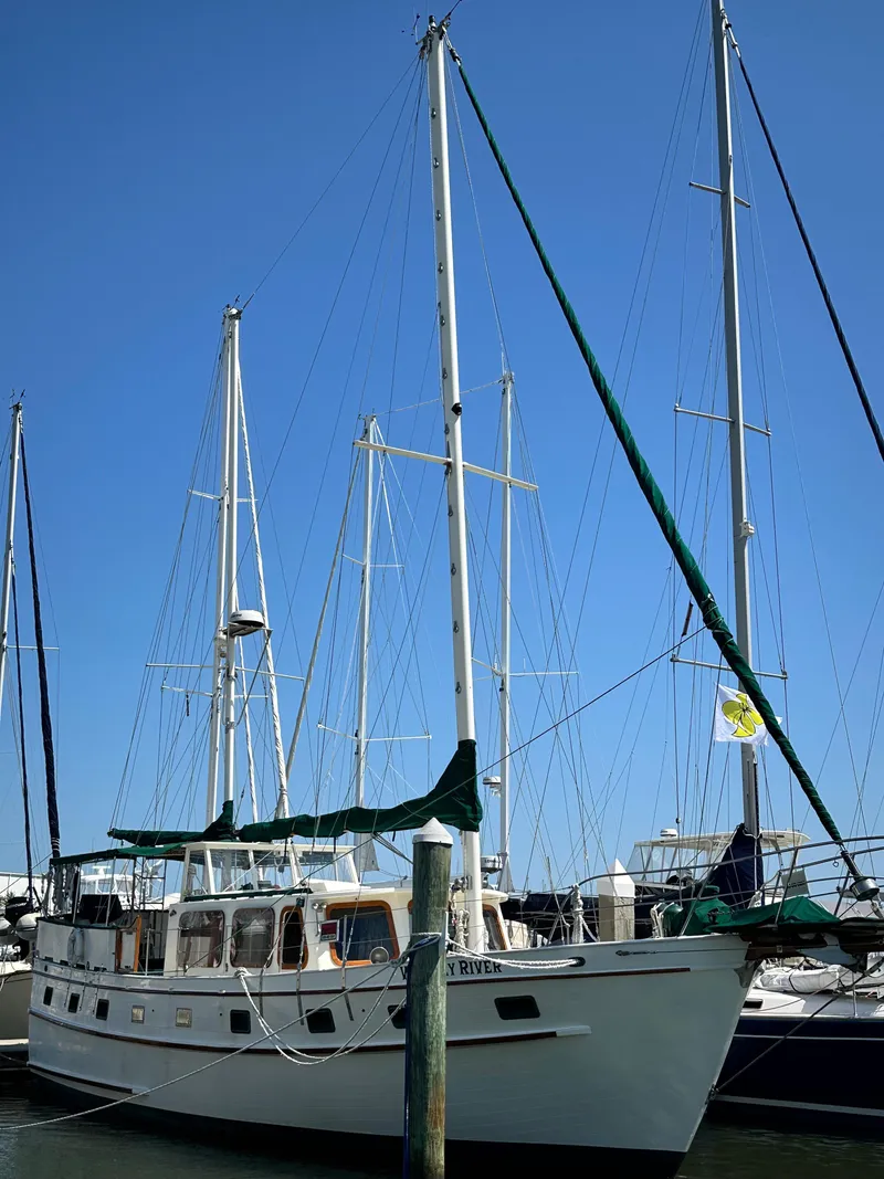 Slide: The Image of 1981 Island Trader 46 sailboat docked at marina under clear blue sky. - 37
