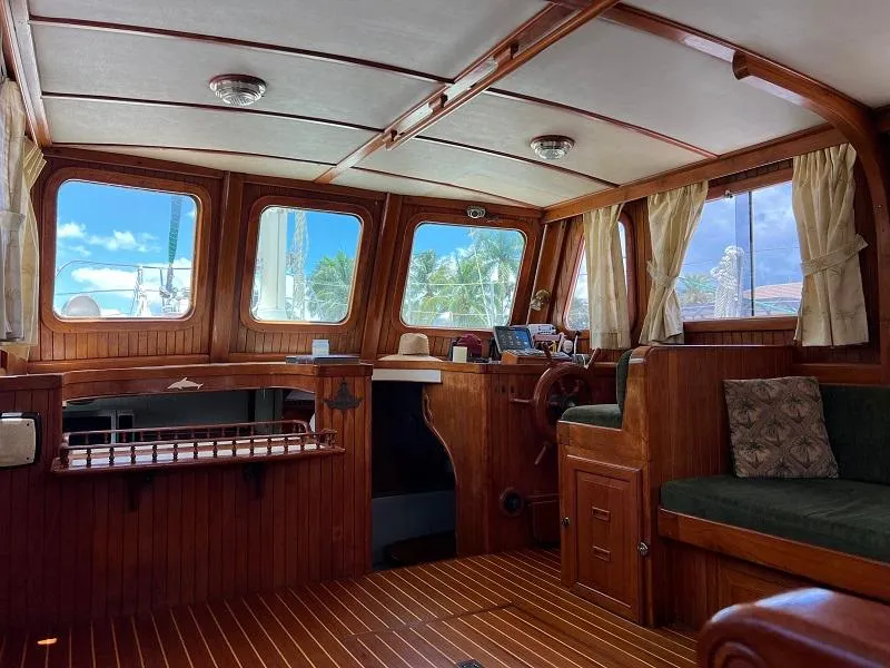 Slide: The Image of Interior of 1981 Island Trader 46 yacht with wooden paneling and large windows. - 9