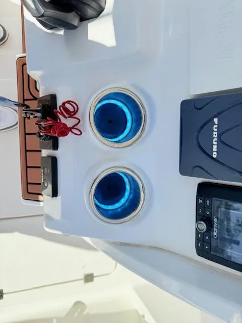 Slide: The Image of 2022 Tidewater 256 CC Adventure boat console with blue LED cup holders and navigation system. - 11