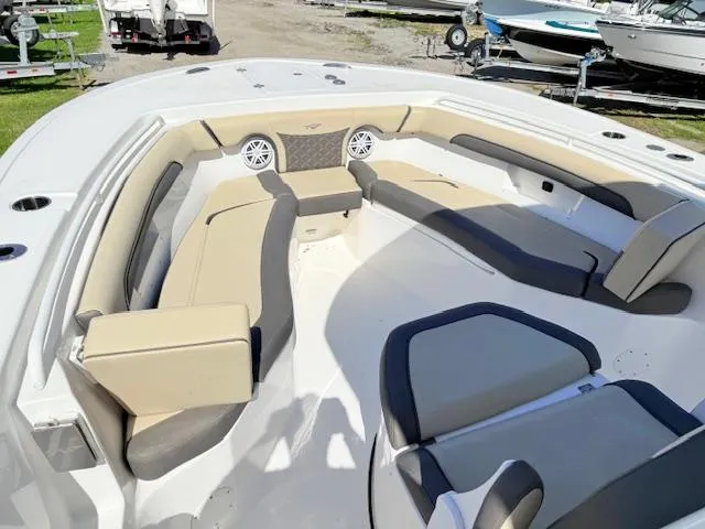 Slide: The Image of 2022 Tidewater 256 CC Adventure boat interior with beige seating and speakers. - 15