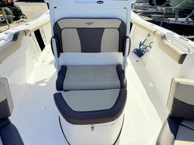Slide: The Image of 2022 Tidewater 256 CC Adventure boat interior with cushioned seating and white deck. - 16