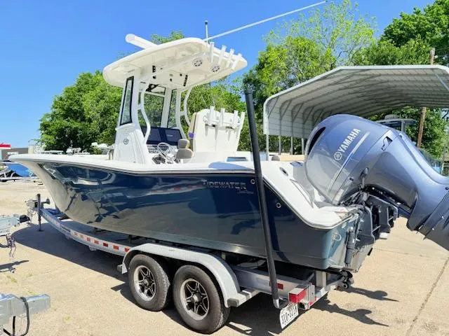 Slide: The Image of 2022 Tidewater 256 CC Adventure boat on trailer with Yamaha engine, parked outdoors. - 4