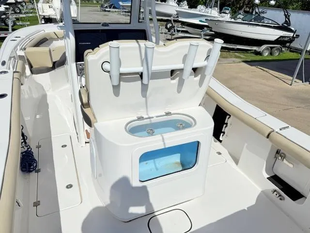Slide: The Image of 2022 Tidewater 256 CC Adventure boat interior with rod holders and livewell. - 5