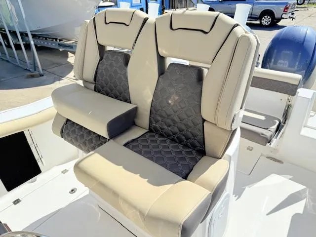 Slide: The Image of 2022 Tidewater 256 CC Adventure boat seats with beige and gray quilted upholstery. - 9