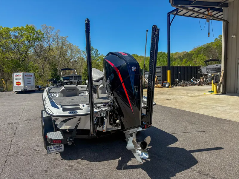Slide: The Image of 2023 Phoenix 721 ProXP boat with powerful outboard motor, parked outdoors on a sunny day. - 10