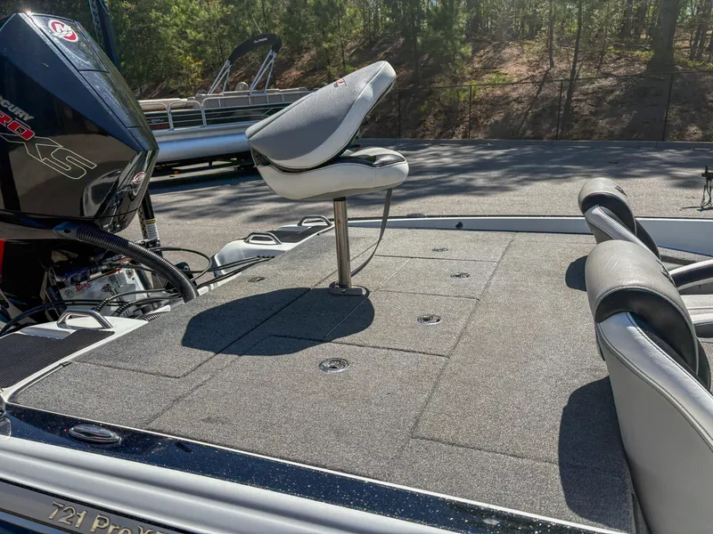 Slide: The Image of 2023 Phoenix 721 ProXP boat deck with seating and motor, outdoors. - 5
