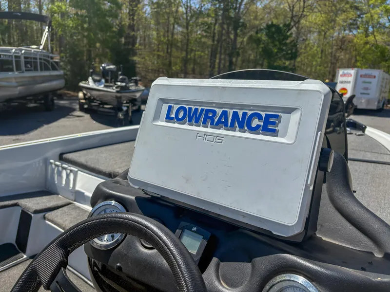 Slide: The Image of 2023 Phoenix 721 ProXP boat with Lowrance HDS system, parked outdoors. - 6