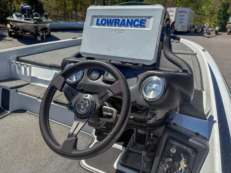 Slide: The Image of 2023 Phoenix 721 ProXP boat dashboard with Lowrance HDS system and steering wheel. - 7