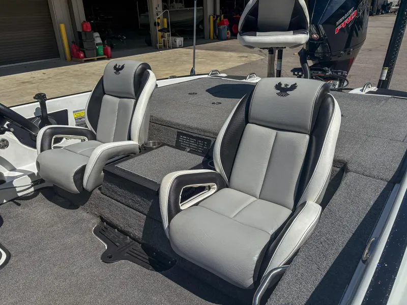 Slide: The Image of 2023 Phoenix 721 ProXP boat interior with two gray seats and a motor in the background. - 8