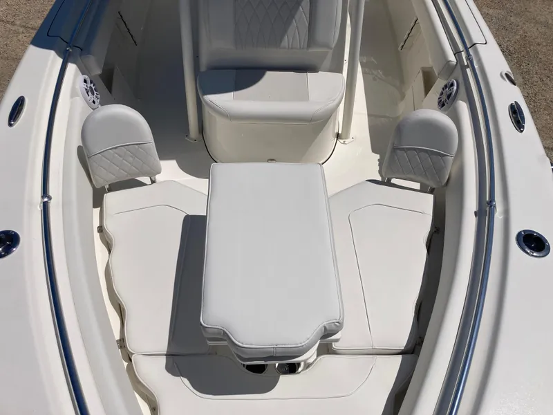 Slide: The Image of 2025 Key West 239FS boat interior with cushioned seating and table. - 10