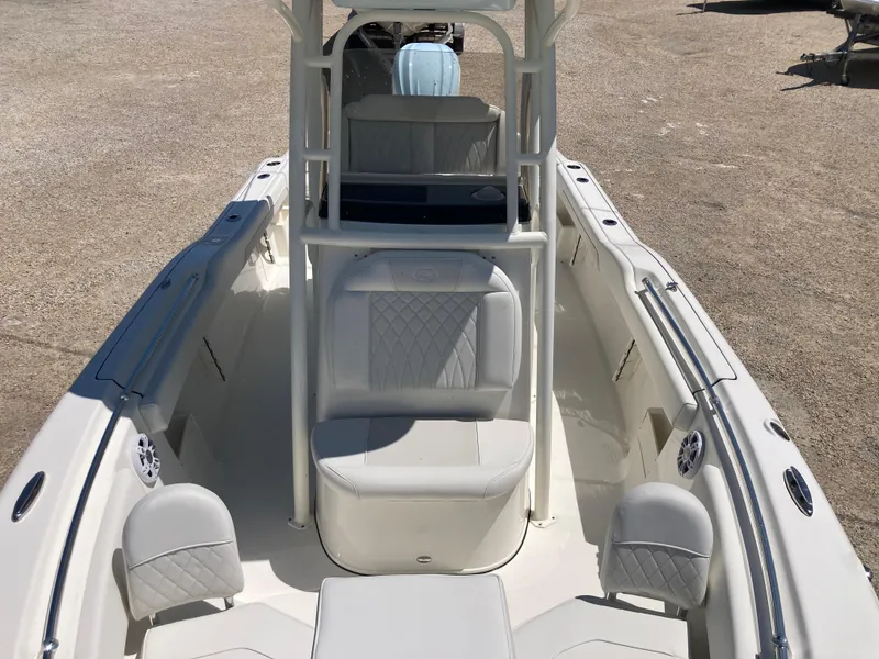 Slide: The Image of 2025 Key West 239FS boat interior with white seating and modern design. - 11