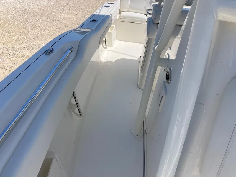 Slide: The Image of 2025 Key West 239FS boat interior, featuring sleek white deck and seating area. - 12