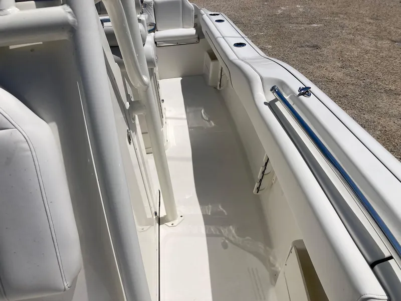 Slide: The Image of 2025 Key West 239FS boat interior with white seating and sleek design. - 13