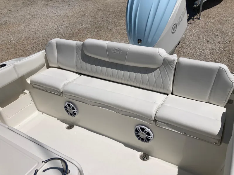 Slide: The Image of 2025 Key West 239FS boat interior with white cushioned seating and built-in speakers. - 17