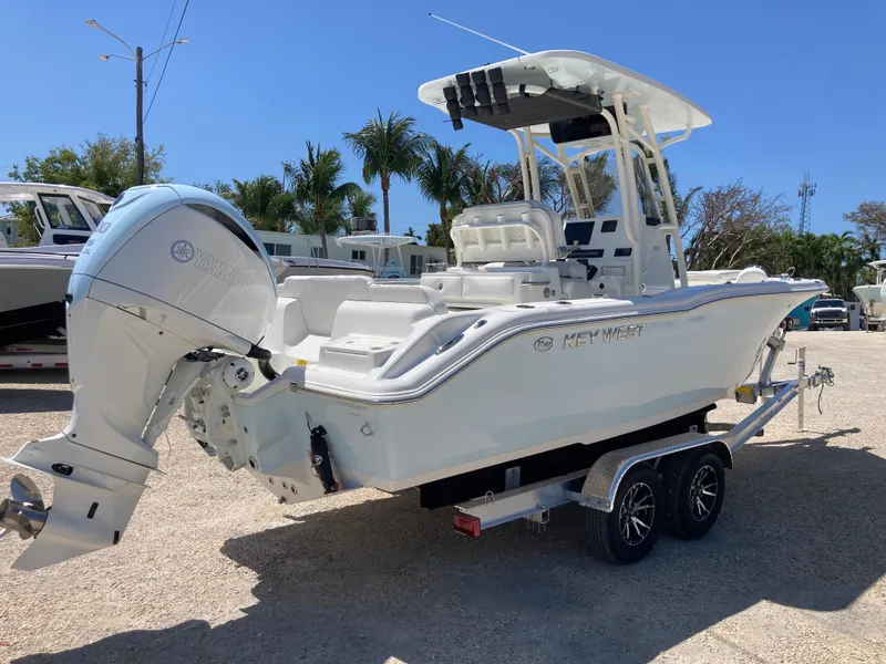 Slide: The Image of 2025 Key West 239FS boat on trailer, parked outdoors under clear blue sky. - 3