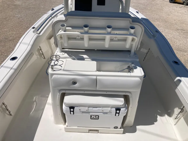 Slide: The Image of 2025 Key West 239FS boat interior with fishing rod holders and cooler. - 6