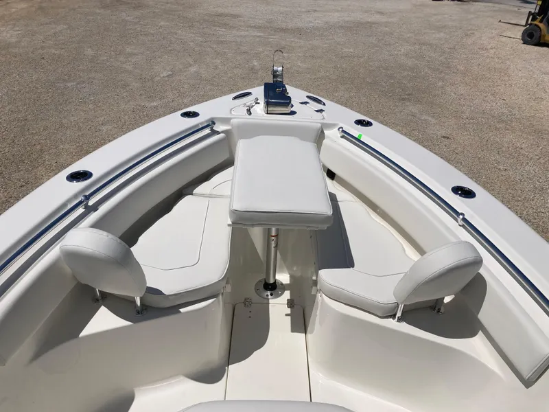 Slide: The Image of 2025 Key West 239FS boat interior with seating and console, showcasing modern design. - 9